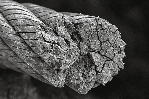 A microscopic view showing metal fatigue cracks in a stiff wire rope after bending